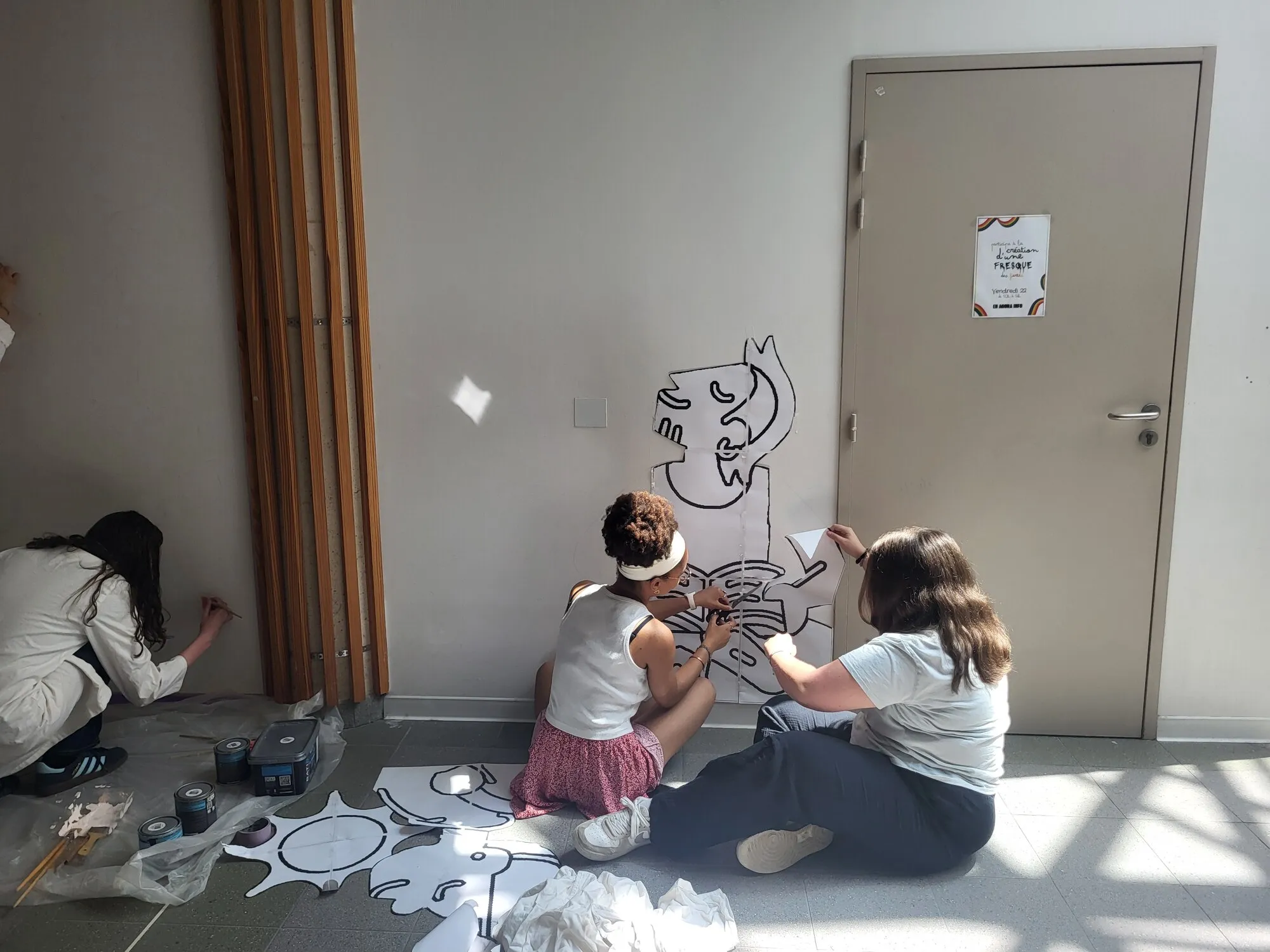 Des élèves préparent une fresque collective sur un mur d’établissement